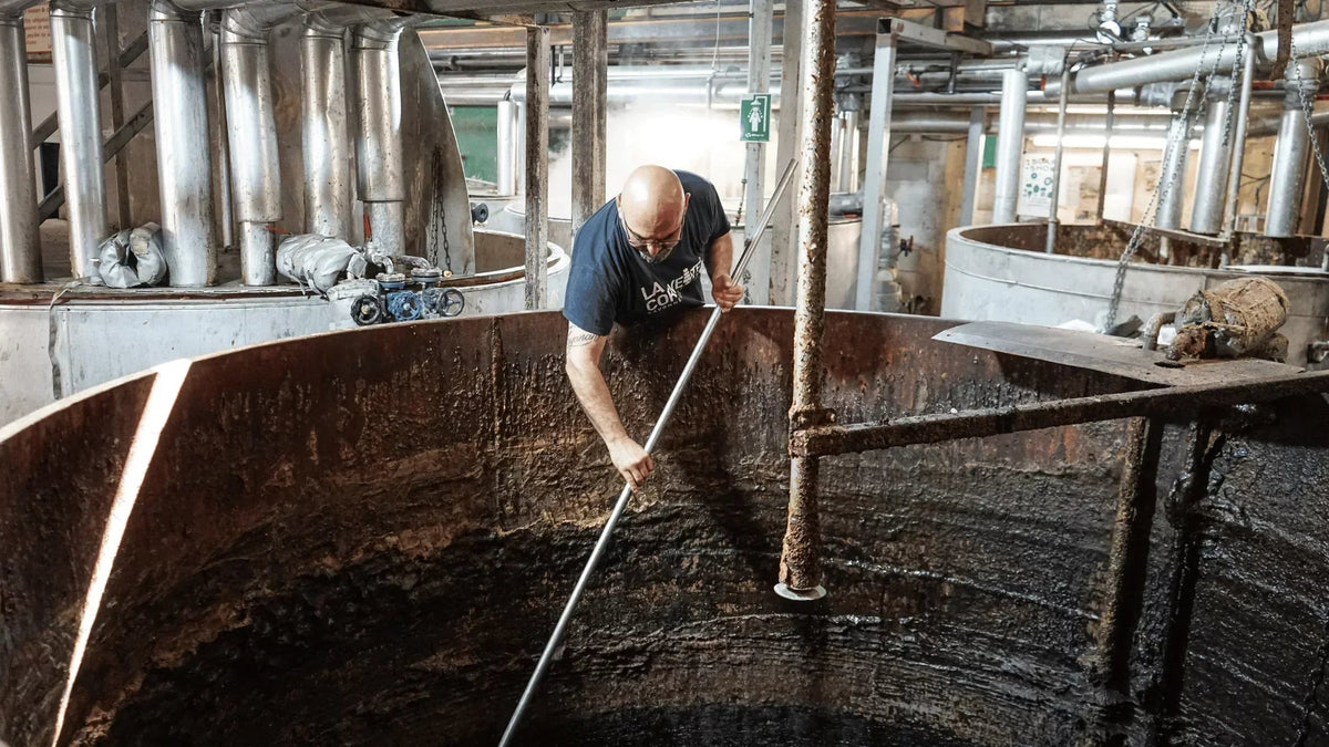 Stirring Olive Oil in a cauldron, soap making