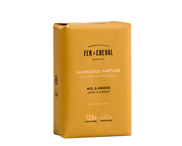 Yellow soap bar packaging with 'Fer a Cheval' branding on a white background