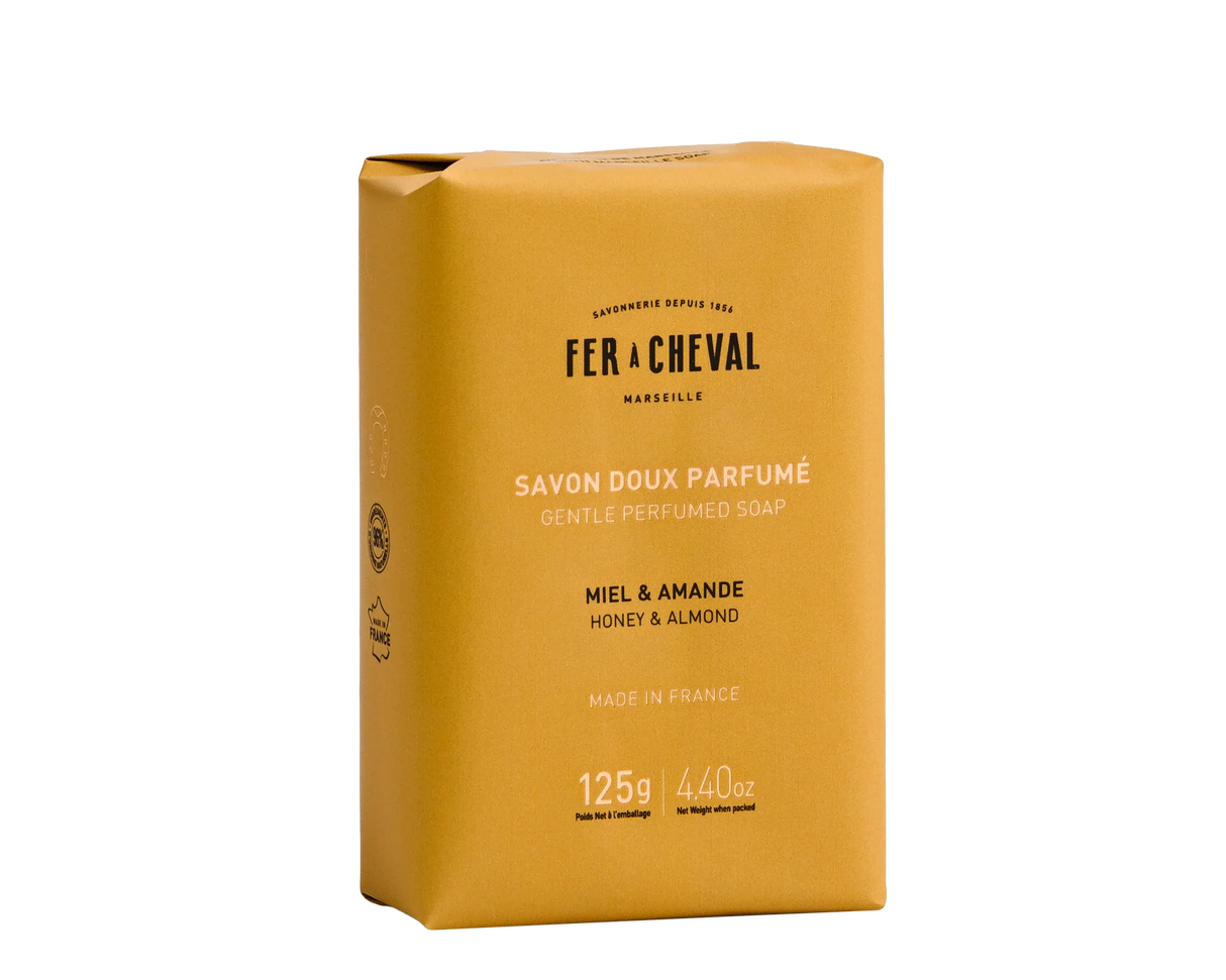 Yellow soap bar packaging with 'Fer a Cheval' branding on a white background