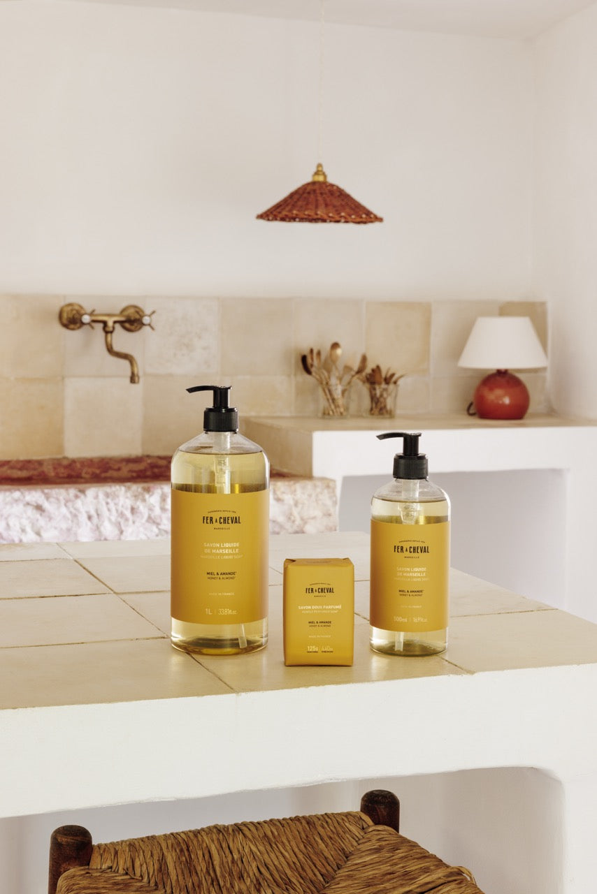 Two bottles of 'For-Cheve' products on a bathroom counter with a lamp and decorative items in the background.