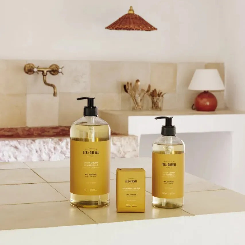 Two bottles of 'For Cheveux' hair care products on a bathroom counter.