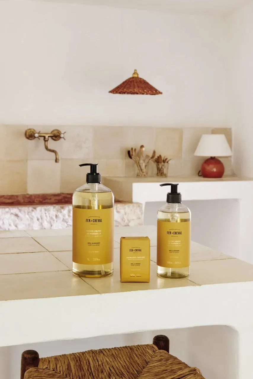 Two bottles of 'For Cheveux' hair care products on a bathroom counter.