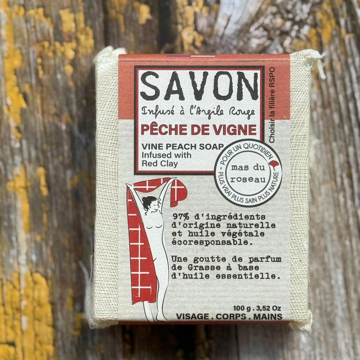 Peach Bar of soap with packaging on a wooden background