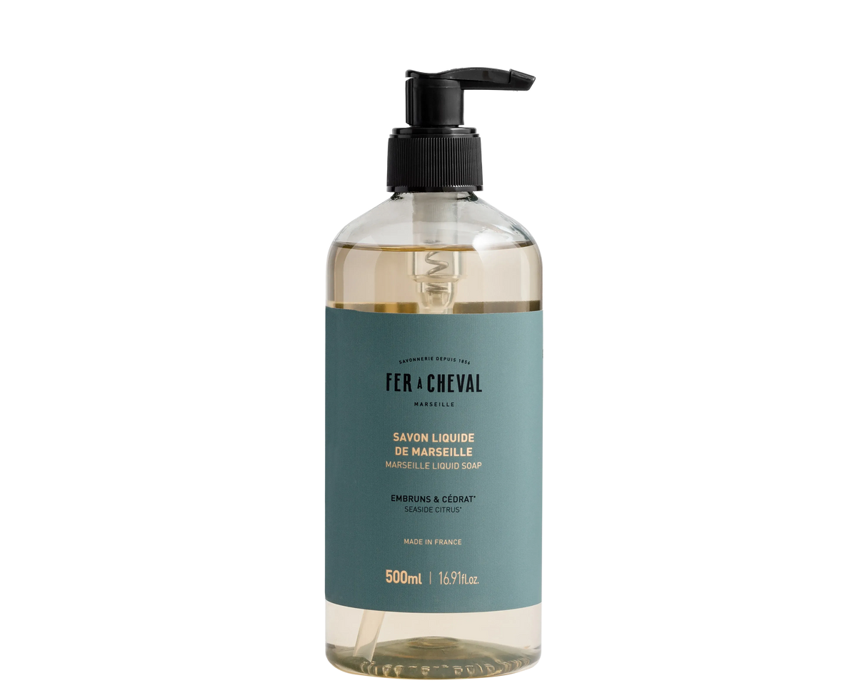 Bottle of Fér à Cheval liquid soap with pump on a white background