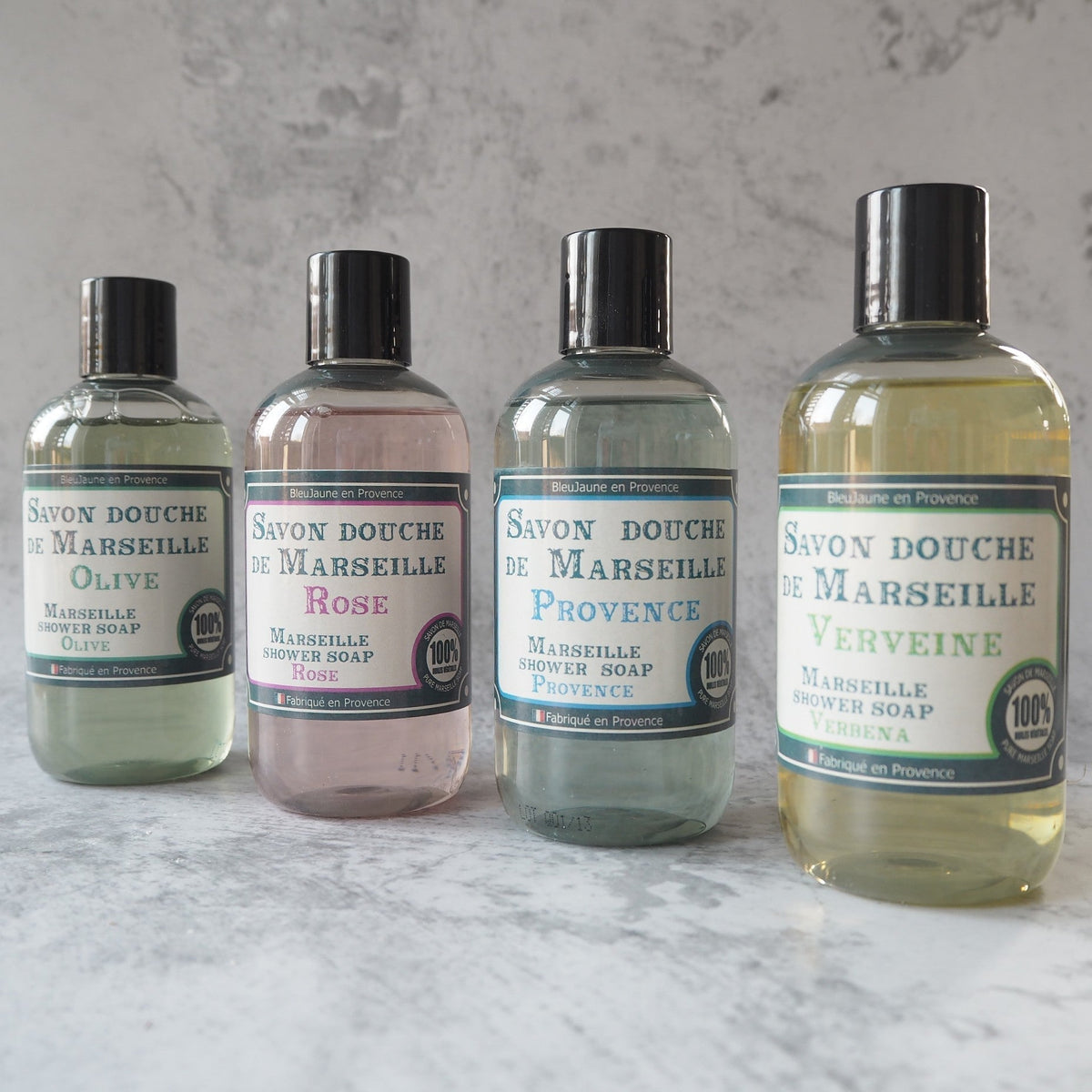 4 small bottle of Marseille Liquid Soap on a bathroom shelf