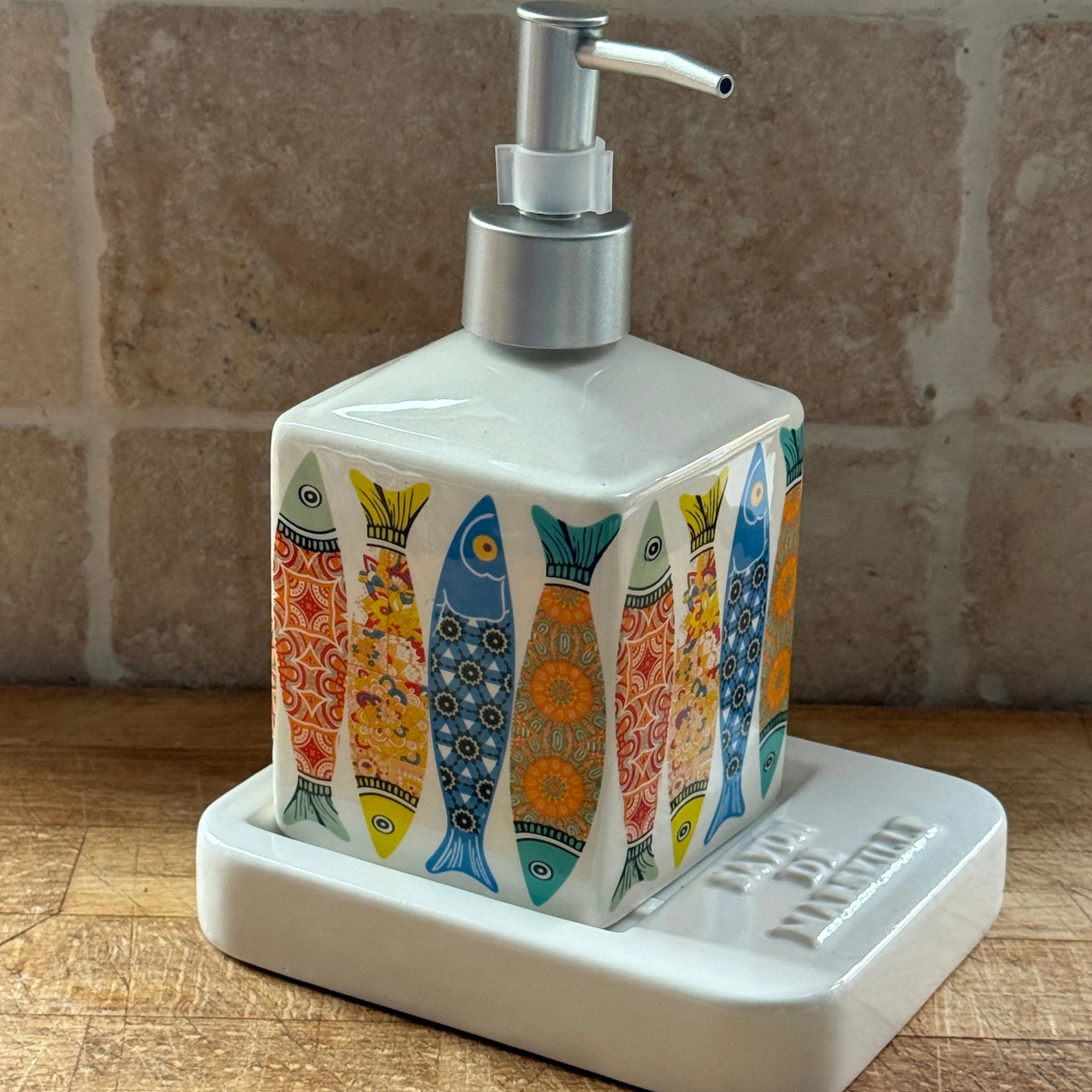 Sardine Ceramic Liquid Soap Dispenser, sitting on a Square ceramic soap dish