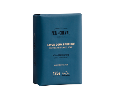 Blue soap packaging with white text on a white background