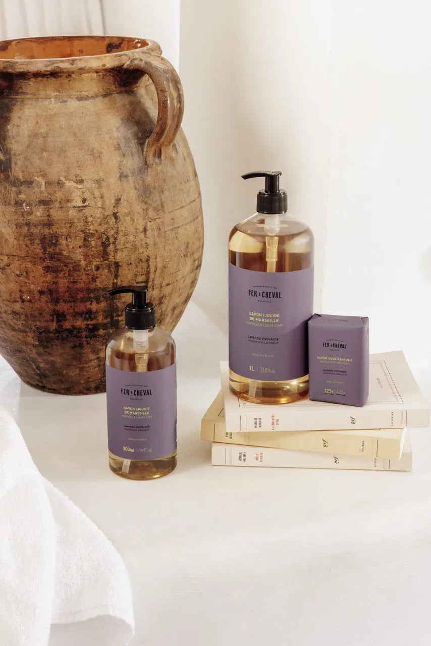 Bath and body products with a rustic vase on a white surface