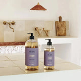 Two bottles of 'Fur & Fur' products on a bathroom counter with a neutral color scheme.