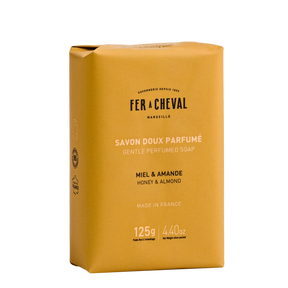 Yellow soap bar packaging with 'Fer a Cheval' branding on a white background