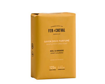 Yellow soap bar packaging with 'Fer a Cheval' branding on a white background