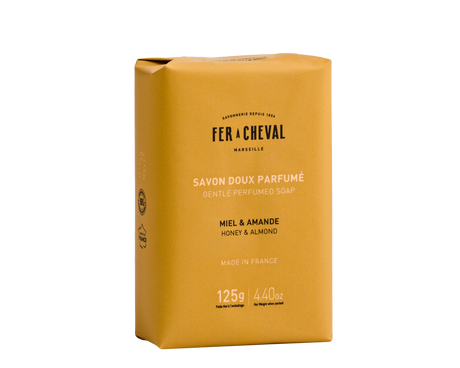 Yellow soap bar packaging with 'Fer a Cheval' branding on a white background