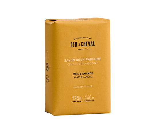 Yellow soap bar packaging with 'Fer a Cheval' branding on a white background