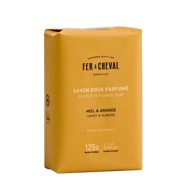 Yellow soap bar packaging with 'Fer a Cheval' branding on a white background