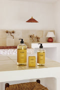Two bottles of 'For Cheveux' hair care products on a bathroom counter.
