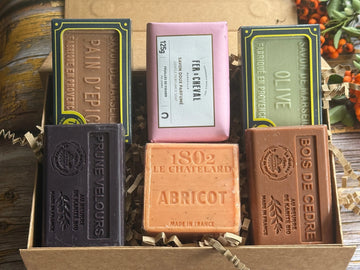Collection of autumn fragranced soap bars with visible branding in a rustic setting