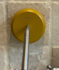 Yellow beechwood soap holder on a tiled wall
