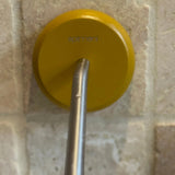 Yellow beechwood soap holder on a tiled wall