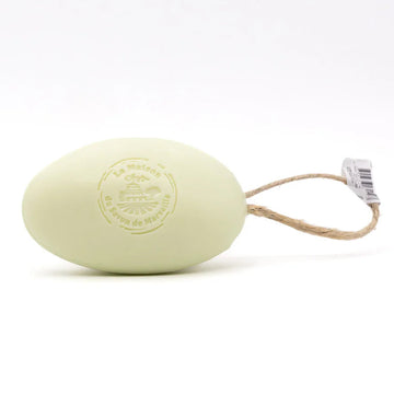 Light green bar of soap on a rope with a visible brand logo against a white background