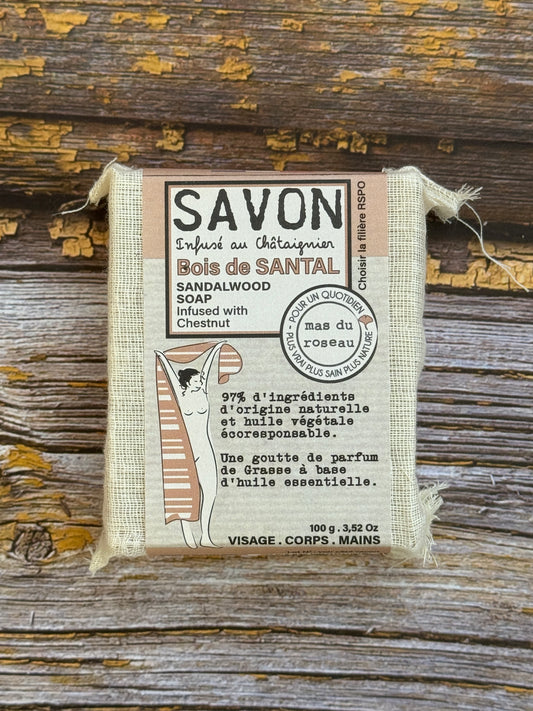 Sandalwood Bar of soap with a label on a wooden background