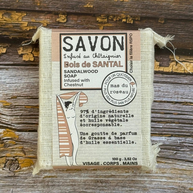 Sandalwood Bar of soap with a label on a wooden background