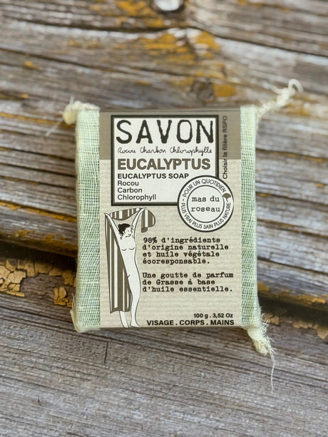 Eucalyptus soap bar with packaging on a wooden surface