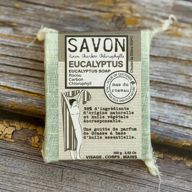 Eucalyptus soap bar with packaging on a wooden surface