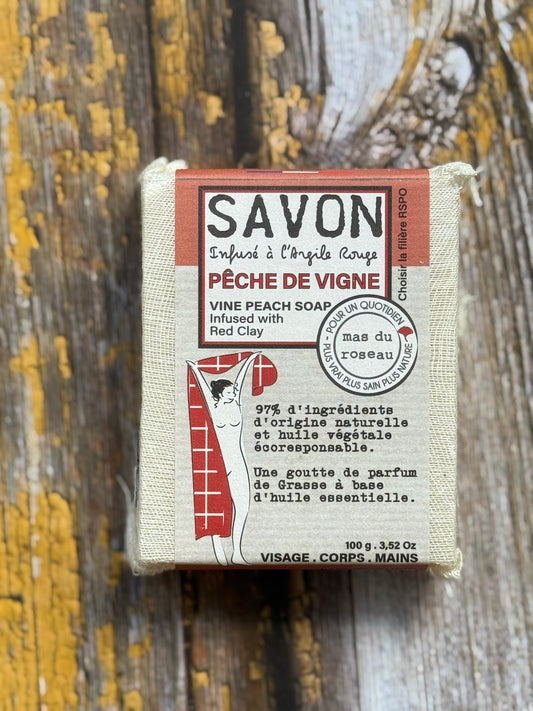 Peach Bar of soap with packaging on a wooden background