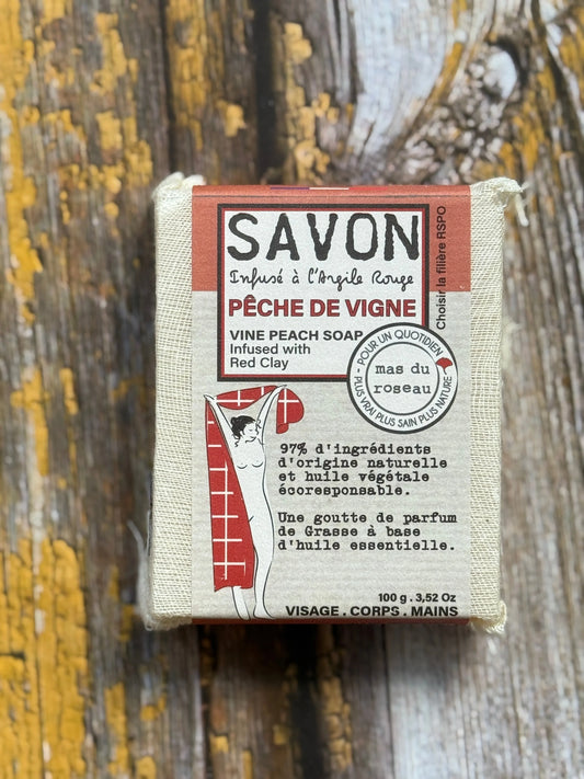 Peach Bar of soap with packaging on a wooden background