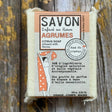 Citrus Bar of soap with a label on a wooden background