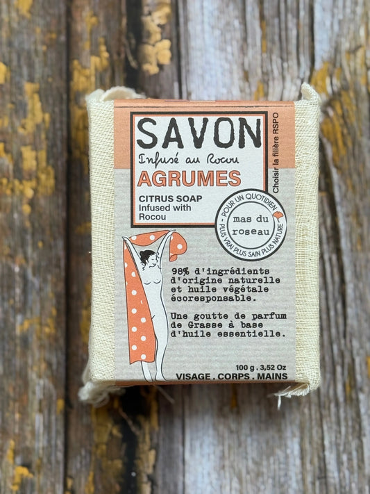 Citrus Bar of soap with a label on a wooden background