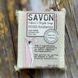 Bar of soap with a label on a wooden background