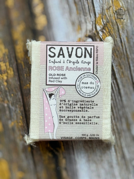 Bar of soap with a label on a wooden background