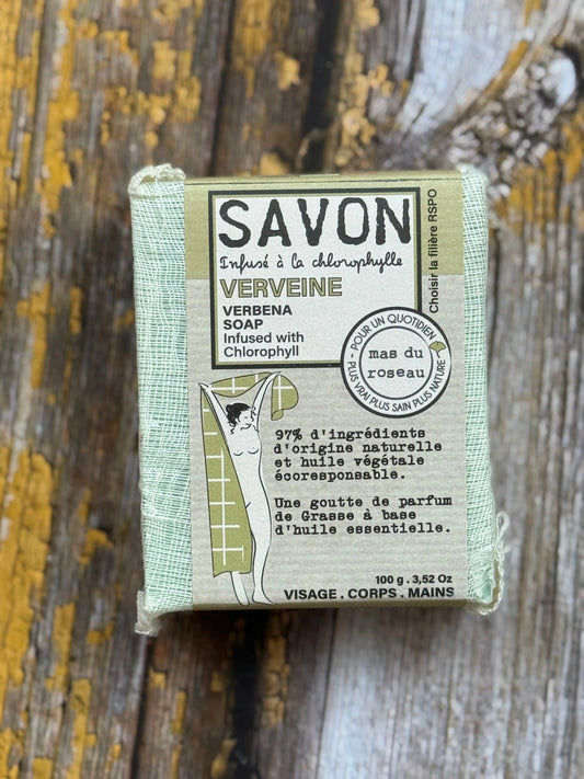 Bar of soap with packaging on a wooden surface