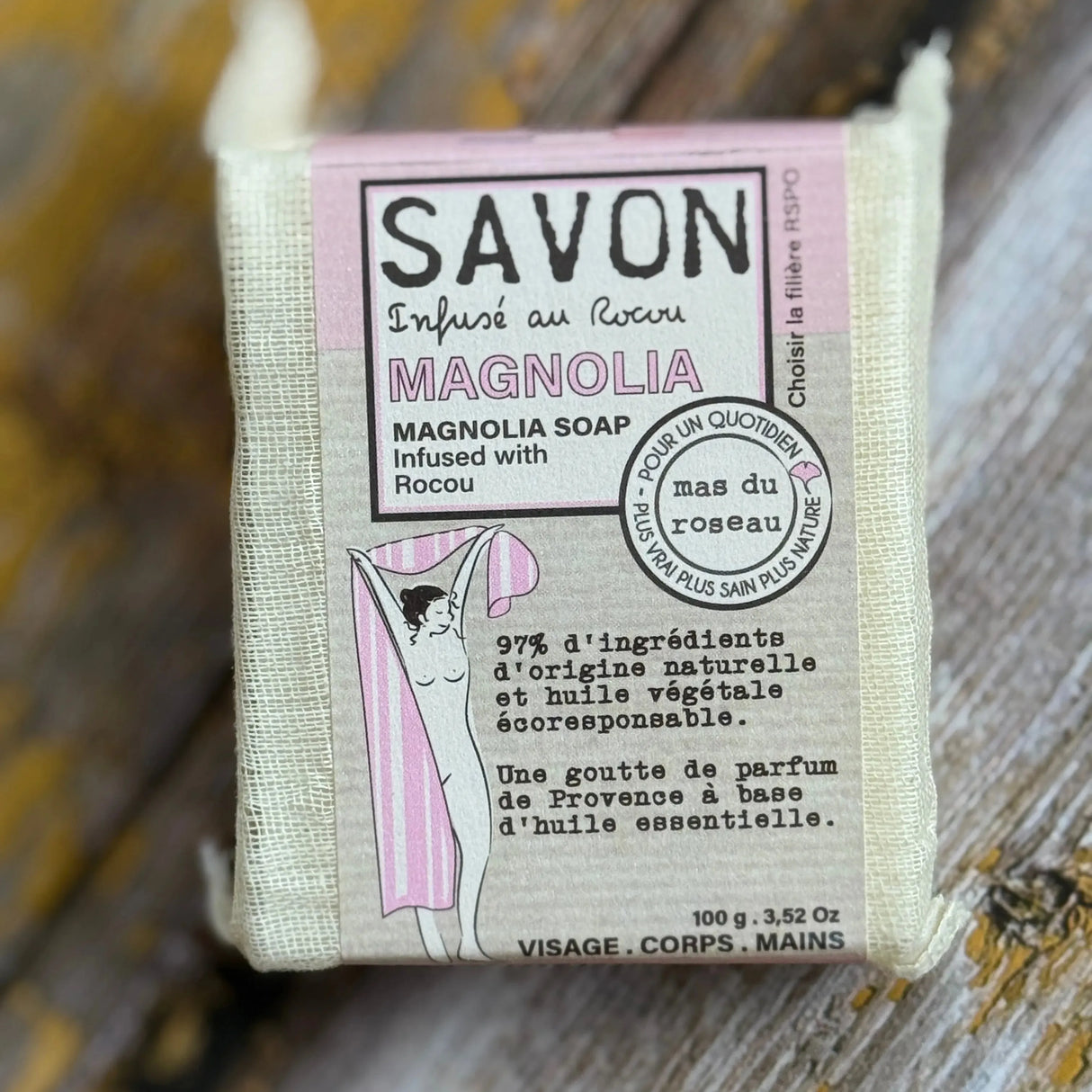 Magnolia Bar of soap with a label on a wooden surface