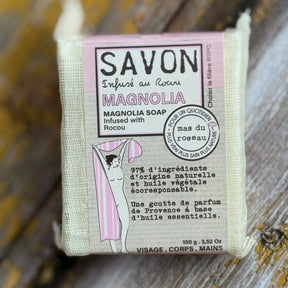 Magnolia Bar of soap with a label on a wooden surface