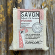 Peony Bar of soap with a pink label on a wooden background