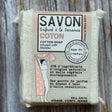 Cotton soap bar with packaging on a wooden surface