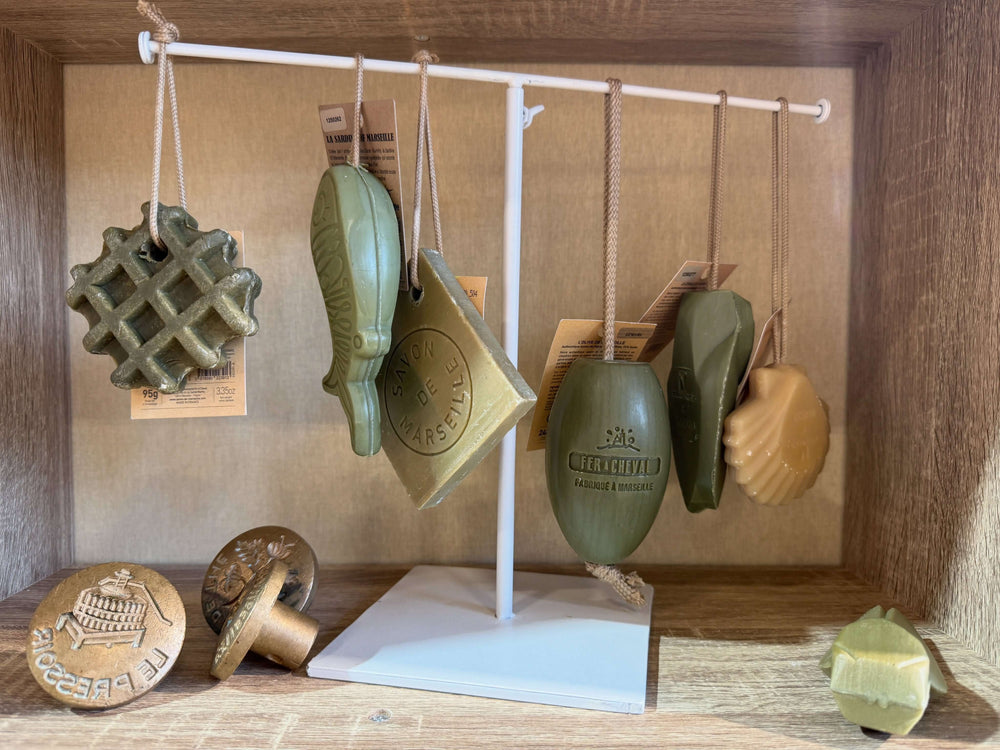 A Collection of pure olive oil soap on a ropes from Fer a Cheval in novelty shapes in a wooden cube. French Soaps UK