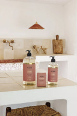 Two bottles of soap on a kitchen counter with a neutral color scheme.