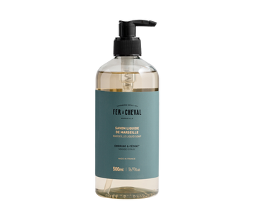 Bottle of Fér à Cheval liquid soap with pump on a white background