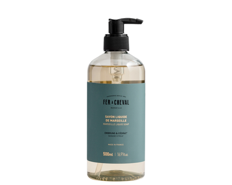 Bottle of Fér à Cheval liquid soap with pump on a white background