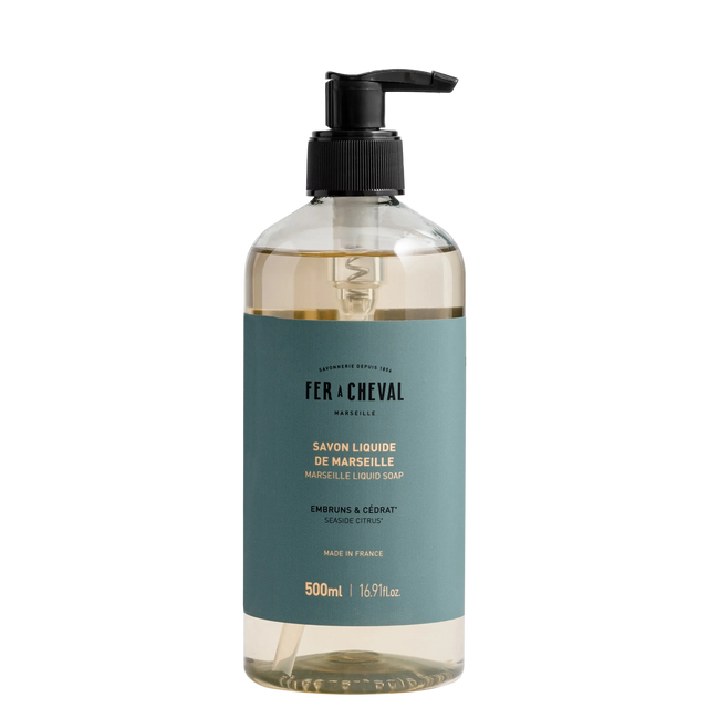 Bottle of Fér à Cheval liquid soap with pump on a white background