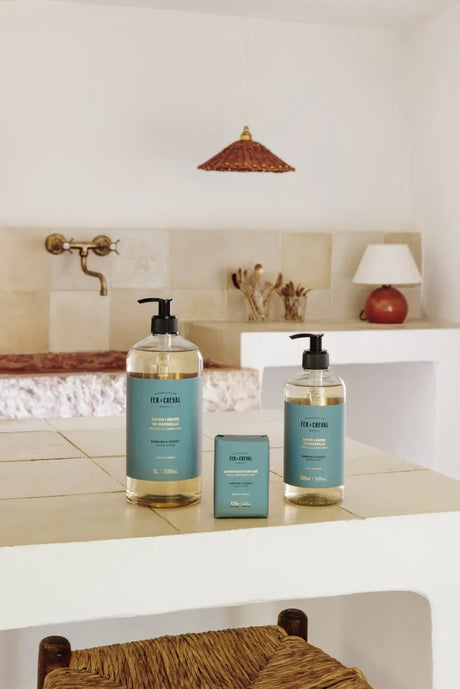 Bathroom setting with two bottles of soap and a small container on a counter.
