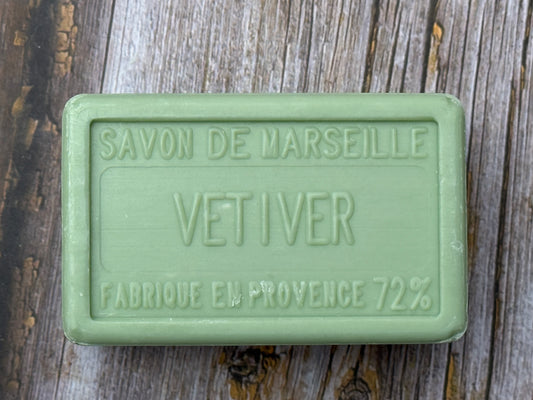 Green soap bar labeled 'Savon de Marseille Vetiver' on a wooden surface