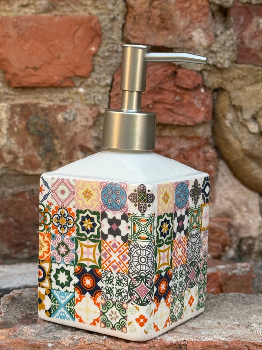 Decorative soap dispenser with colorful pattern on a brick wall background

