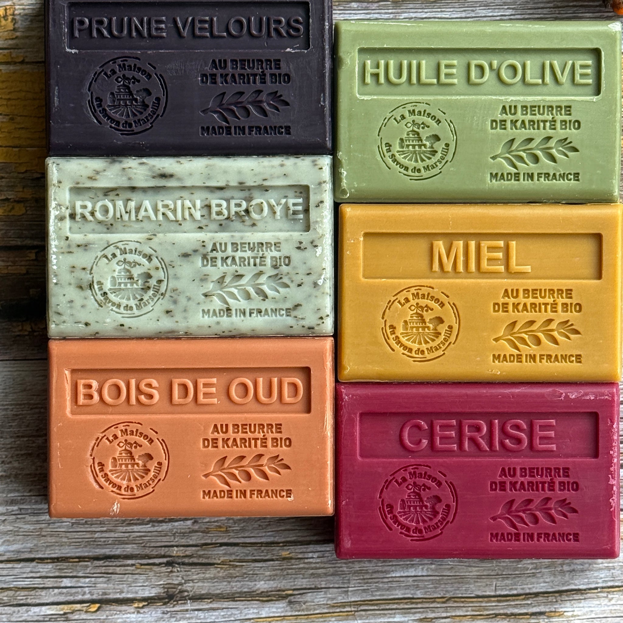 Set of colourful Autumnal soap bars with embossed text on a wooden surface