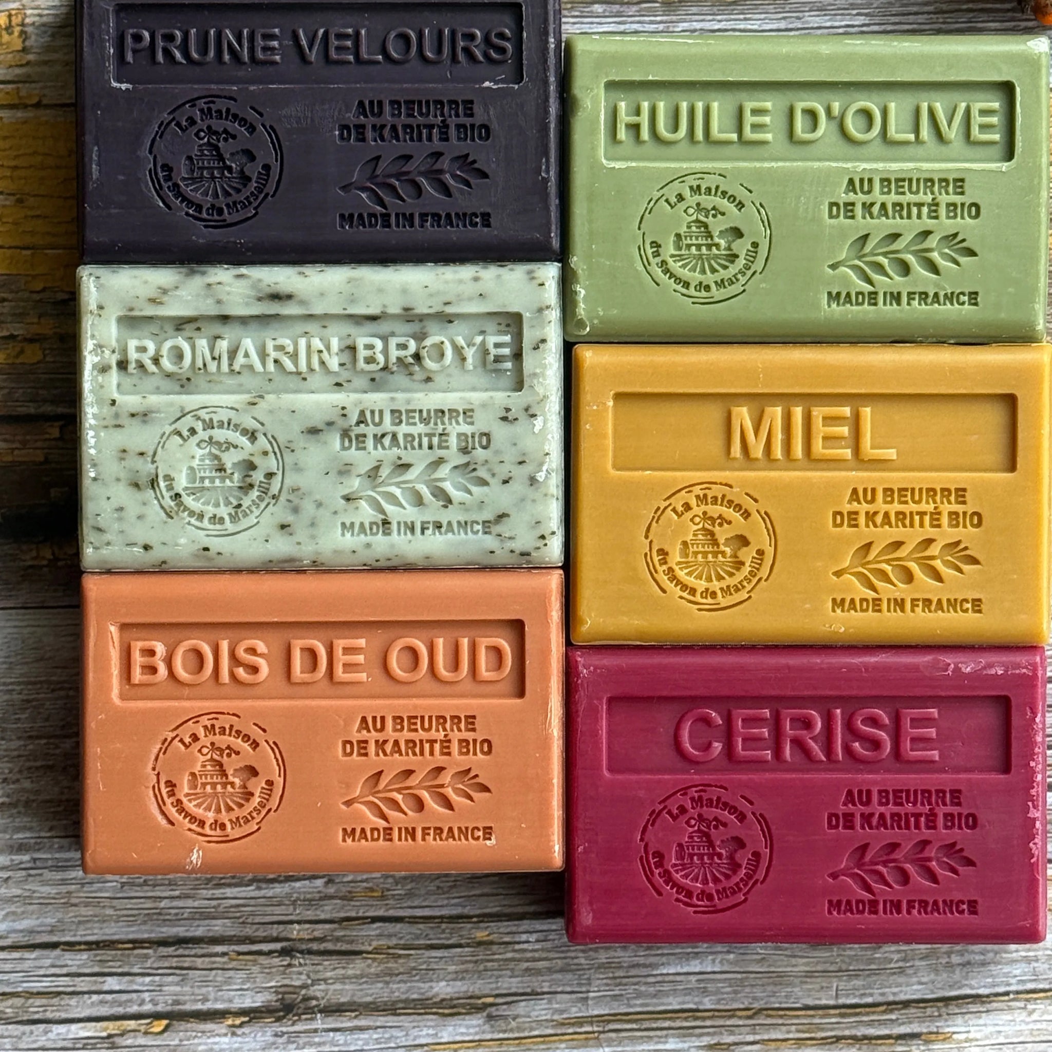Set of colourful Autumnal soap bars with embossed text on a wooden surface