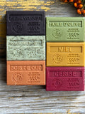 Set of colourful Autumnal soap bars with embossed text on a wooden surface