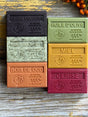 Set of colourful Autumnal soap bars with embossed text on a wooden surface